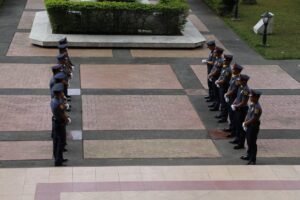 Police officers in uniform standing in symmetrical formation in the Philippines.
