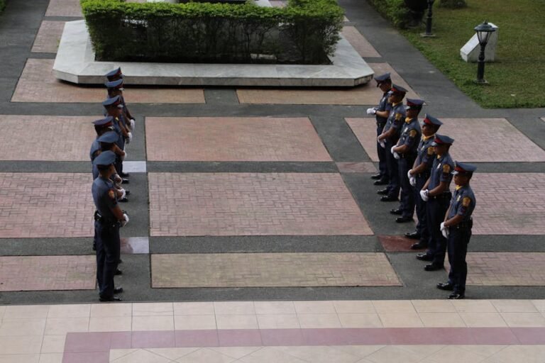Police officers in uniform standing in symmetrical formation in the Philippines.