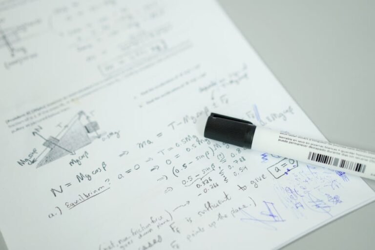Close-up showing mathematical formulas and a marker on bond paper, ideal for education themes.